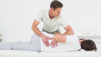 chiropractor performing lumbar spine manipulation